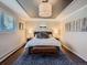 Cozy main bedroom featuring a tray ceiling, a large rug, and a seating bench at 9931 E Ida Pl, Greenwood Village, CO 80111