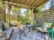Charming outdoor patio area with comfortable seating, a fire pit, and lush greenery at 9931 E Ida Pl, Greenwood Village, CO 80111