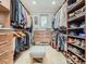Large walk-in closet with custom shelving, built-in drawers, and ample storage space at 9931 E Ida Pl, Greenwood Village, CO 80111