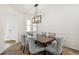 Dining room with a wood table and gray upholstered chairs at 25018 E Canal Pl, Aurora, CO 80018