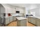 Modern kitchen with white and gray cabinets and a large island at 25018 E Canal Pl, Aurora, CO 80018