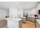 Modern kitchen with white and gray cabinets and a large island at 25018 E Canal Pl, Aurora, CO 80018