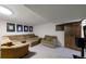 A finished basement with a large sectional, arm chair, and carpeted flooring at 7567 Parkview Mtn, Littleton, CO 80127