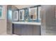 Bathroom vanity with double sinks, storage cabinets, white countertop, blue mosaic tile backsplash, and mirrors at 7567 Parkview Mtn, Littleton, CO 80127