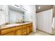 A full bathroom with a double sink, marble countertops, tiled floor and shower at 7567 Parkview Mtn, Littleton, CO 80127
