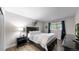Bedroom with a dark frame bed, and a desk area next to a window with natural light at 7567 Parkview Mtn, Littleton, CO 80127