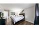 A primary bedroom features a dark wood bed frame, closet with mirrored doors, and hard wood floors at 7567 Parkview Mtn, Littleton, CO 80127