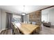 Elegant dining room featuring a large wooden table, modern chairs, and a partial brick wall at 7567 Parkview Mtn, Littleton, CO 80127