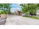 Exterior home elevation showing a two car garage, a landscaped yard, and solar panels on the roof at 7567 Parkview Mtn, Littleton, CO 80127