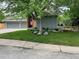 Charming home featuring a well-manicured lawn, mature trees, a two-car garage, and a welcoming front entrance at 7567 Parkview Mtn, Littleton, CO 80127