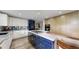 Stylish kitchen with two-tone cabinetry, gas cooktop, large island, and modern finishes at 7567 Parkview Mtn, Littleton, CO 80127
