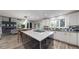 Modern kitchen boasts a large center island, contemporary cabinetry, and an open design to the living area at 7567 Parkview Mtn, Littleton, CO 80127