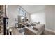 Bright living room boasts high ceilings, a tall window, and comfortable seating around a stone fireplace at 7567 Parkview Mtn, Littleton, CO 80127