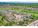 Neighborhood aerial view showcasing single Gathering homes, green space, and mountain views in the distance at 6652 W Asbury Pl, Lakewood, CO 80227