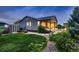 Spacious backyard with a covered patio, garden boxes, lawn, and beautiful landscaping at 6652 W Asbury Pl, Lakewood, CO 80227