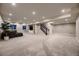 Large finished basement with carpet, recessed lighting, built-in shelves, and a comfortable seating area at 6652 W Asbury Pl, Lakewood, CO 80227