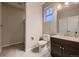Bathroom featuring a single vanity with dark cabinets, tiled floors, shower, and modern fixtures at 6652 W Asbury Pl, Lakewood, CO 80227