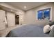 Bedroom featuring a comfortable bed, large window, and closet with sliding doors at 6652 W Asbury Pl, Lakewood, CO 80227