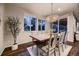 Elegant dining room with wood table, chandelier, and large windows offering scenic outdoor views at 6652 W Asbury Pl, Lakewood, CO 80227