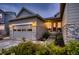 Charming home with a two-car garage, stone accents, and a well-maintained front yard at 6652 W Asbury Pl, Lakewood, CO 80227