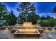 Outdoor fire pit with brick surround and landscaping for entertaining at 6652 W Asbury Pl, Lakewood, CO 80227