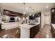 Open-concept kitchen and living area featuring modern finishes and hardwood floors at 6652 W Asbury Pl, Lakewood, CO 80227