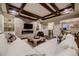 Modern living room featuring coffered ceilings, a stone fireplace, and built-in shelving at 6652 W Asbury Pl, Lakewood, CO 80227