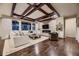 Open living room featuring a stone fireplace, built-in shelving, and a coffered ceiling at 6652 W Asbury Pl, Lakewood, CO 80227