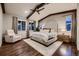 Spacious main bedroom boasts wood floors, vaulted ceilings, exposed beams, and a comfortable seating area at 6652 W Asbury Pl, Lakewood, CO 80227