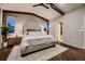 Spacious main bedroom boasts wood floors, vaulted ceilings, exposed beams, and a comfortable seating area at 6652 W Asbury Pl, Lakewood, CO 80227