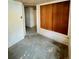 Unfinished basement area showing concrete walls, storage, and doorway to another room at 4549 S Acoma S St, Englewood, CO 80110