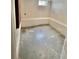 Unfinished basement with concrete floor and walls, with a built-in bench along the wall at 4549 S Acoma S St, Englewood, CO 80110