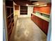 Unfinished basement with utility shelves and cabinets with bare concrete floor at 4549 S Acoma S St, Englewood, CO 80110