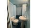 Small bathroom featuring a toilet, pedestal sink, a tiled shower, and a medicine cabinet at 4549 S Acoma S St, Englewood, CO 80110