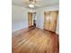 Bedroom with hardwood floors, neutral walls, and closet doors at 4549 S Acoma S St, Englewood, CO 80110