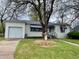 Charming single-story home featuring a garage, well-kept lawn and decorative awnings at 4549 S Acoma S St, Englewood, CO 80110