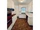 Cozy kitchen with vintage appliances, cabinets, and a unique brown patterned floor at 4549 S Acoma S St, Englewood, CO 80110