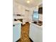 Functional kitchen with white cabinets, dark countertops, and a cozy layout at 4549 S Acoma S St, Englewood, CO 80110
