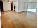 Bright living room featuring hardwood floors, large window, and built-in shelving at 4549 S Acoma S St, Englewood, CO 80110