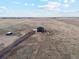 Aerial view capturing a modern house set within a rural landscape at 49601 E 56Th Ave, Bennett, CO 80102