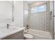 Clean white tiled bathroom with shower and tub combination at 49601 E 56Th Ave, Bennett, CO 80102
