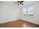 Bright bedroom with hardwood floors, a ceiling fan, and plenty of natural light from the two large windows at 49601 E 56Th Ave, Bennett, CO 80102