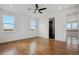 Spacious bedroom with hardwood floors, ceiling fan, natural light, and an en-suite bathroom at 49601 E 56Th Ave, Bennett, CO 80102