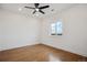 Bright bedroom with hardwood floors, a ceiling fan, and plenty of natural light from the large window at 49601 E 56Th Ave, Bennett, CO 80102
