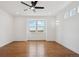 Bright bedroom featuring hardwood floors, a ceiling fan, a large window, and recessed lighting at 49601 E 56Th Ave, Bennett, CO 80102