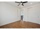 Bright bedroom features hardwood floors, a ceiling fan, and access to the upper level at 49601 E 56Th Ave, Bennett, CO 80102