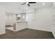 Bonus room showing the bar area, neutral carpet, and recessed lighting at 49601 E 56Th Ave, Bennett, CO 80102