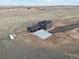 Aerial view of a two-story home featuring an attached garage, a concrete driveway and a rural setting at 49601 E 56Th Ave, Bennett, CO 80102