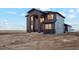Elegant two-story home with a black and gray exterior, highlighting its modern design and spacious layout at 49601 E 56Th Ave, Bennett, CO 80102