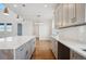Modern kitchen featuring a large center island with light grey cabinets and quartz countertops at 49601 E 56Th Ave, Bennett, CO 80102